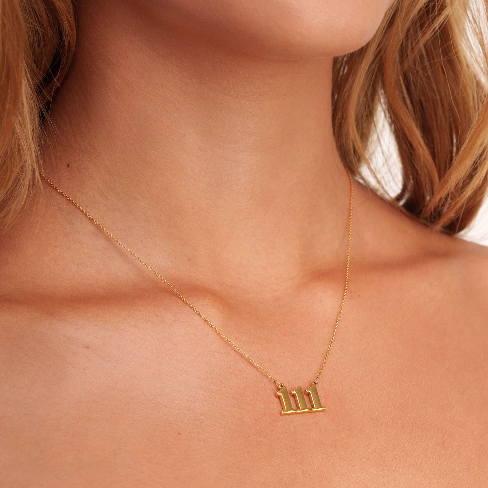 gold necklace with 111 pendant