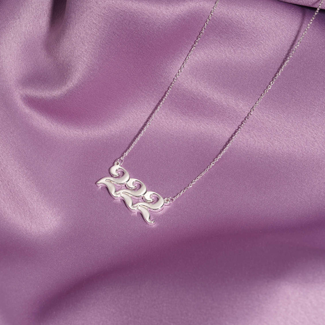 silver 222 necklace on silk