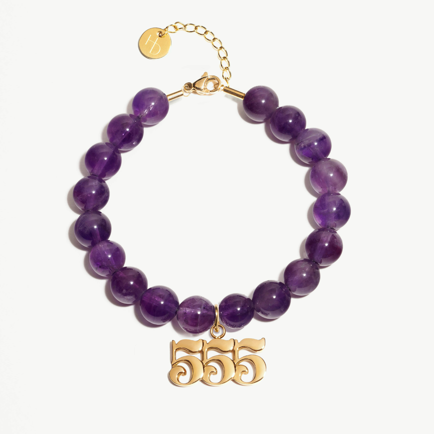 555 amethyst beaded bracelet with adjustable clasp closure. 555 gold charm