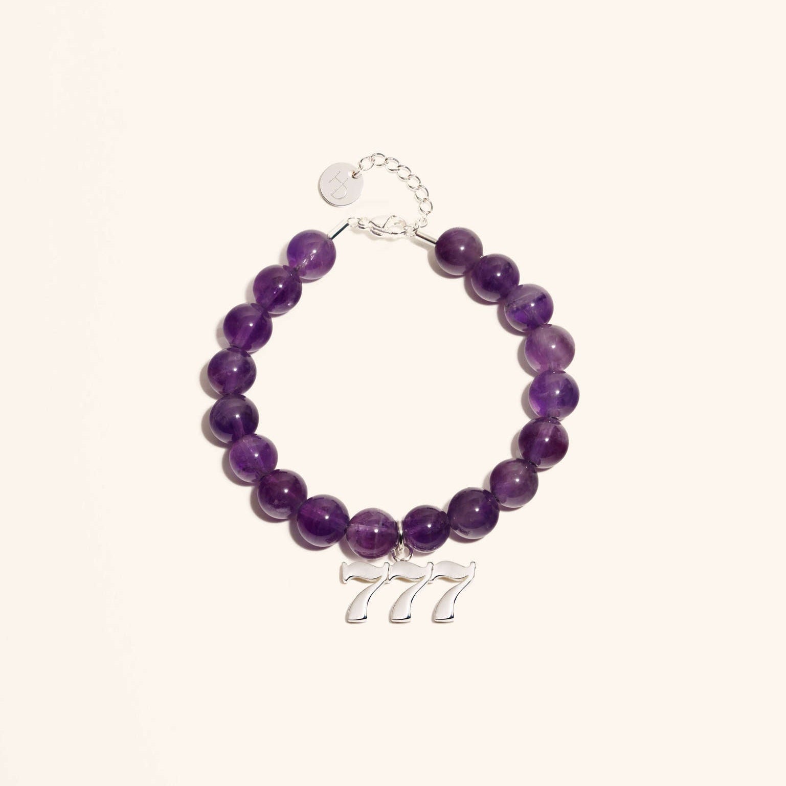 An amethyst gemstone bracelet with a silver 777 angel number charm, featuring a lobster clasp closure.