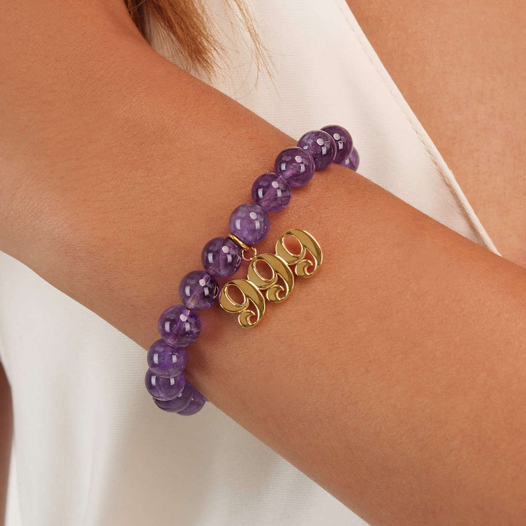 High quality purple amethyst beads with dangling 999 gold charm on wrist