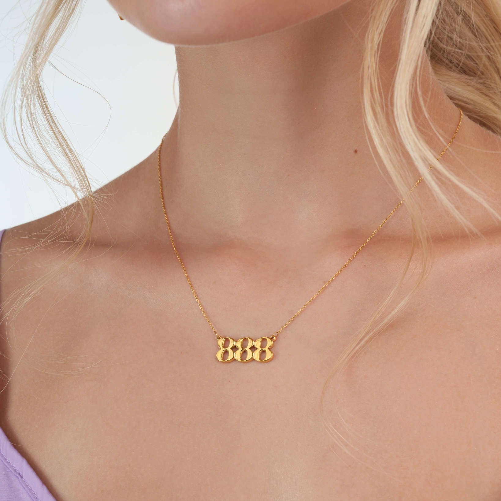 woman wearing gold 888 necklace with premium feel