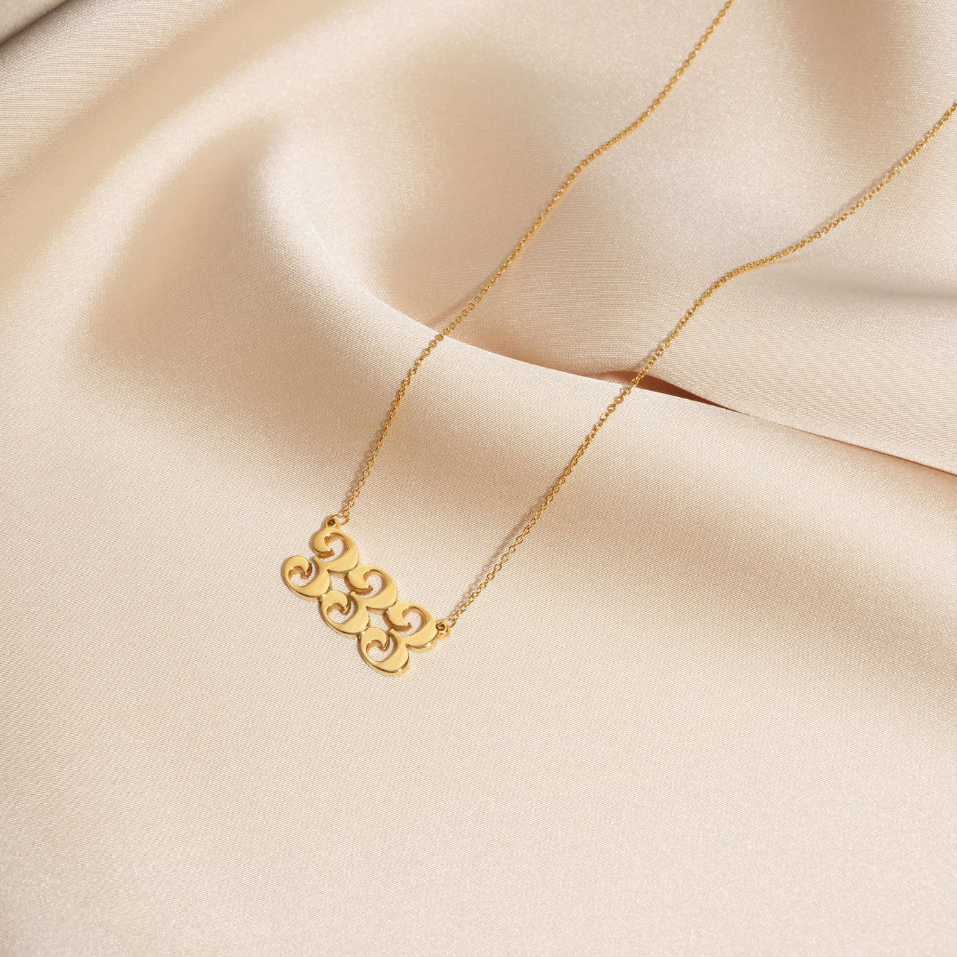 333 gold necklace on silk