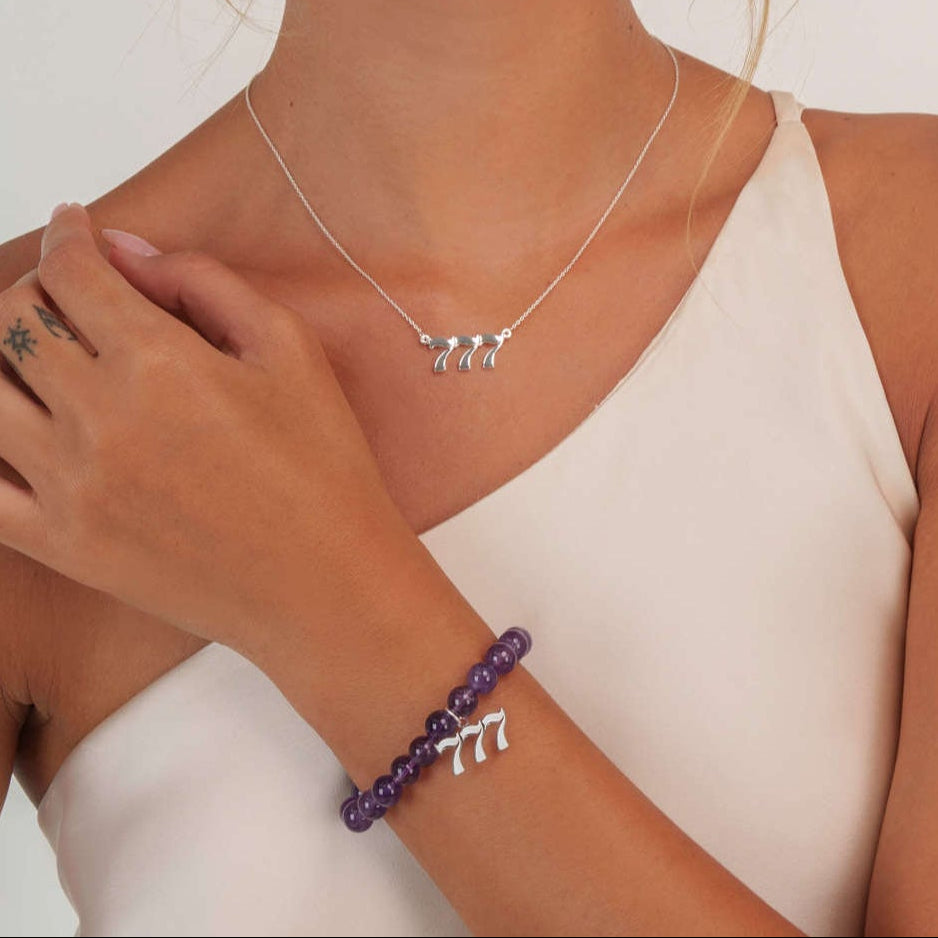 Model wearing an amethyst 777 silver bracelet with a matching 777 silver necklace
