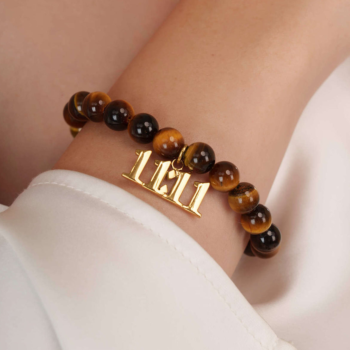 High quality Tigers Eye beads with dangling 11:11 Gold charm on wrist
