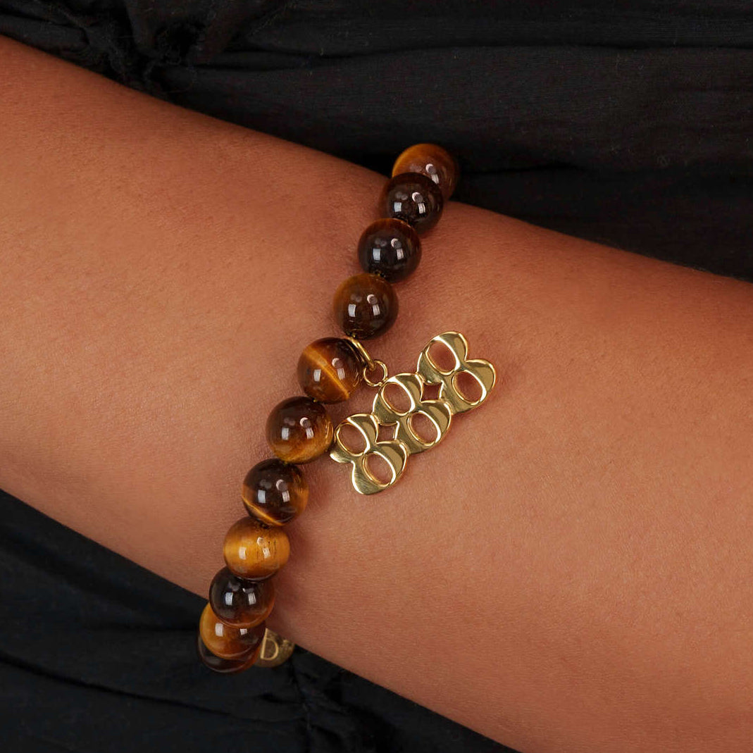 High quality Tigers Eye beads with dangling 888 Gold charm on wrist
